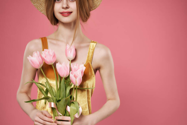 vaaleanpunainen kukkakimppu käsissä naisen kultainen mekko ylellinen koristelu - Valokuva, kuva