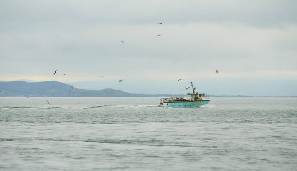 Fishing boat in the open sea. - Foto, Bild