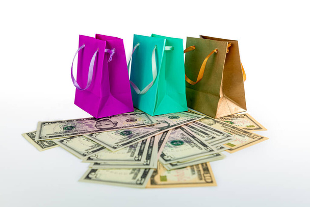 Shopping bags and US dollar banknotes isolated on white background, shopping spending concept - 写真・画像