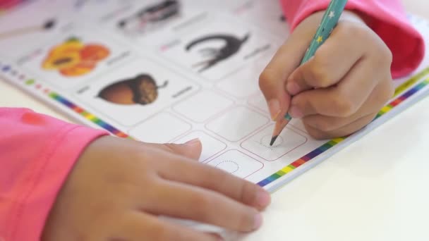 Enfoque selectivo niño pequeño mano escribir alfabeto A en el libro de trabajo - Imágenes, Vídeo
