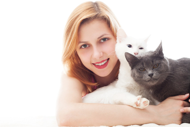 young girl hugging two cats and cute smiles - Foto, Imagen