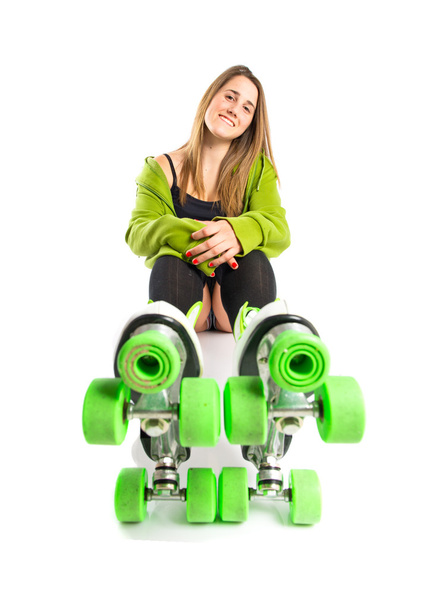 Blonde girl with rollerblade over white background - Photo, image