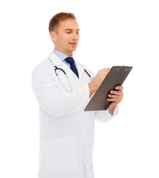 smiling male doctor with clipboard and stethoscope - Фото, изображение