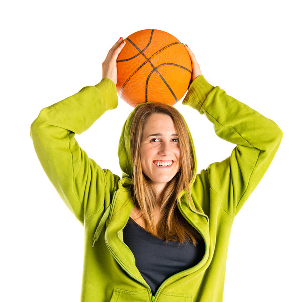 Blonde girl playing basketball over white background - Foto, imagen
