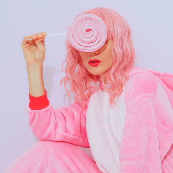 Pretty Pink Pajamas Party Girl. Lollipop candy lover. Home Relax style. Kigurumi shop concept - Fotó, kép
