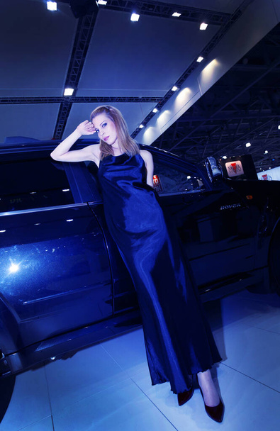 08-05-2008 Moscow russia. Russian model posing next to chinese Hoover car - 写真・画像