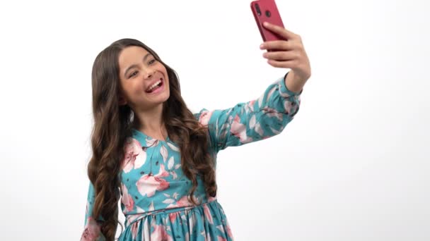 happy child making selfie on smartphone with peace gesture and texting message, modern communication - Footage, Video
