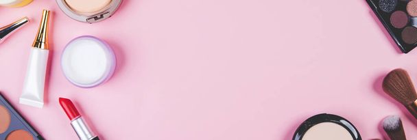 Conjunto de herramienta de maquillaje cosmético aislado sobre fondo rosa, vista superior, plancha, pincel y lápiz labial y kit de paleta de maquillaje, sin personas, nadie, espacio de copia, objeto de grupo sobre la belleza, maquillaje de colección. - Foto, imagen