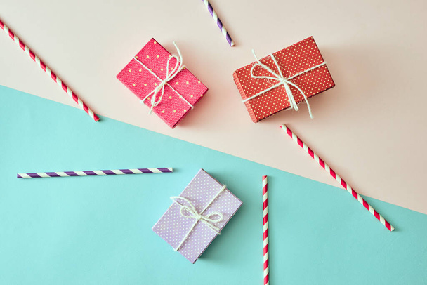 present boxes with ribbon on pink canvas background - Fotó, kép