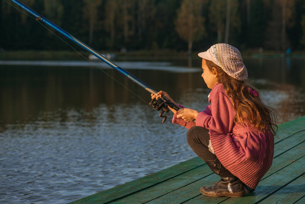 little girl catches fishing rod - Photo, Image