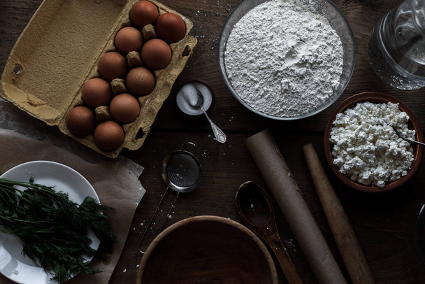A top view of flour and eggs on the table used for baking - Valokuva, kuva