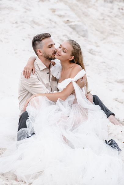 Beautiful wedding couple bride and groom at wedding day outdoors at ocean beach. Happy marriage - Foto, Bild