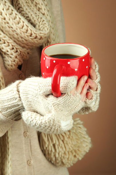 Female hands with hot drink, on color background - Valokuva, kuva