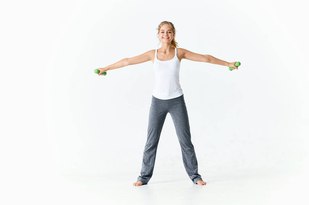 woman exercising with dumbbells motivation slim figure workout - Foto, Imagen