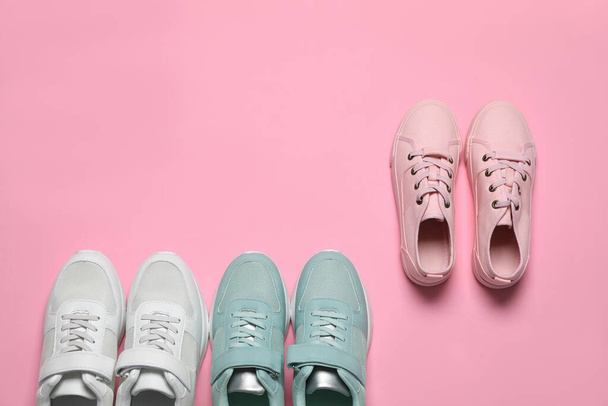 Different stylish sports shoes on pink background, flat lay. Space for text - Valokuva, kuva