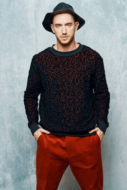 man in black sweater red pants posing studio self-confidence - Zdjęcie, obraz