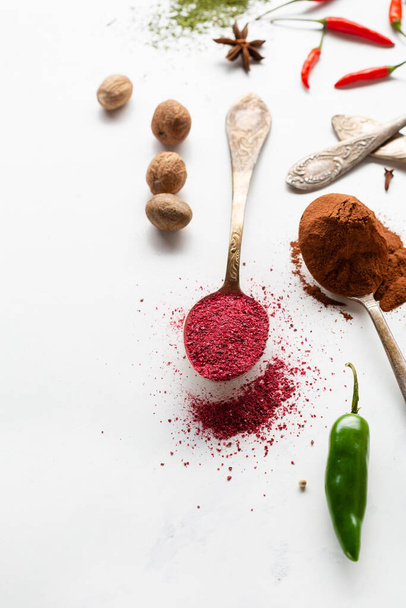 spice powder on spoons chilli pepper and nutmeg cinnamon - 写真・画像