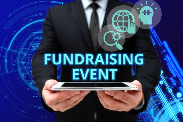 Text showing inspiration Fundraising Event. Business concept campaign whose purpose is to raise money for a cause Man In Office Uniform Holding Tablet Displaying New Modern Technology. - Photo, Image