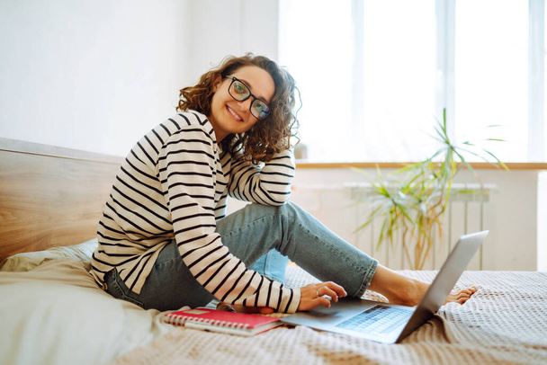 Young woman working online or studying and learning while using notebook at home. Technology, freelance, shopping online, remote work, E learning concept. - Foto, Imagem