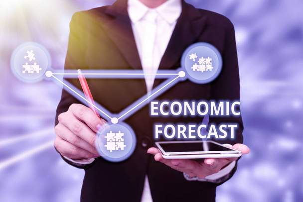 Conceptual caption Economic Forecast. Word Written on attempting to predict the future condition of the economy Lady In Uniform Holding Tablet In Hand Virtually Typing Futuristic Tech. - Photo, Image