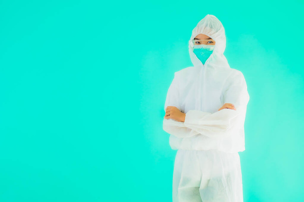 Portrait beautiful young asian doctor woman wear ppe or  personal protective equipment for protect from coronavirus or covid19 on blue isolated background - Foto, imagen