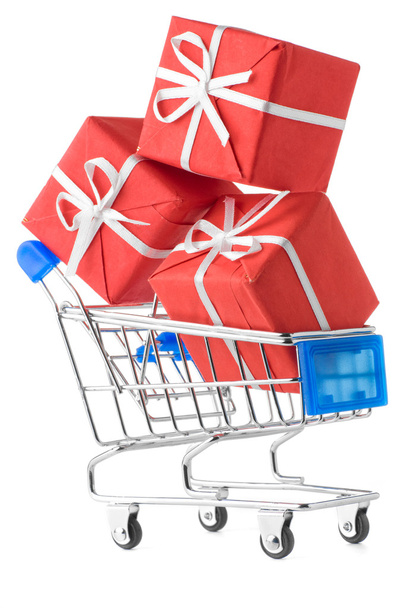 Closeup of a shopping cart with gifts isolated on white - Fotó, kép