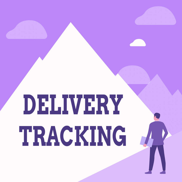Hand writing sign Delivery Tracking. Conceptual photo the process of localizing shipping containers and mails Gentleman In Suit Standing Holding Notebook Facing Tall Mountain Range. - Foto, Imagen