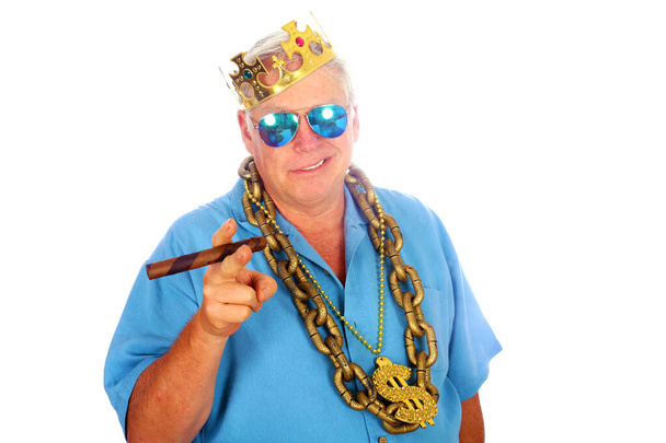 King of the Photo Booth. A happy man wears his King Crown and Gold Chain while in a Photo Booth. A happy man laughs, sings, and makes funny faces and smiles while in a Photo booth at a Party. Party Time Photo Booth. Wedding Photo Booth. Birthday Fun. - Photo, Image