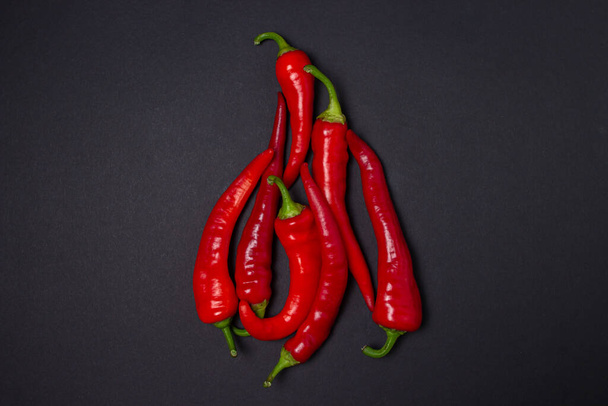 Red hot chili peppers on a black background. Chili pepper isolated - Φωτογραφία, εικόνα