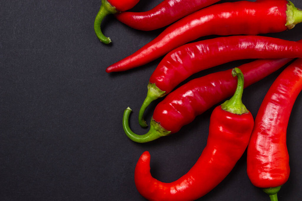 Red hot chili peppers on a black background. Chili pepper isolated - Foto, immagini