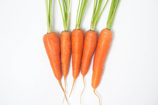 Fresh ripe carrots on a white background. Isolated carrot - Фото, изображение
