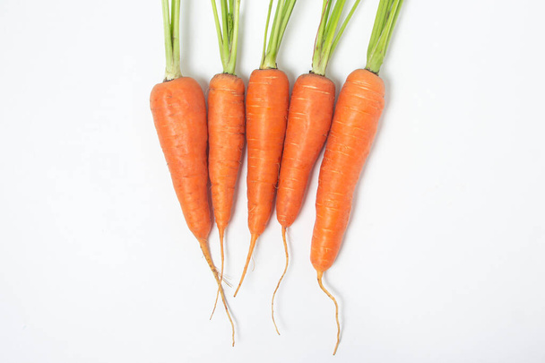 Fresh ripe carrots on a white background. Isolated carrot - Fotografie, Obrázek