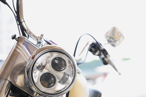 Round motorcycle headlight with handlebars and mirrors closeup - Photo, Image