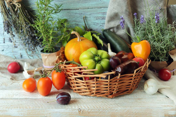 Fresh ripe vegetables and fruits in a basket, on a wooden table, harvest concept, organic natural products, healthy food, home cooking, Thanksgiving Day - Photo, Image