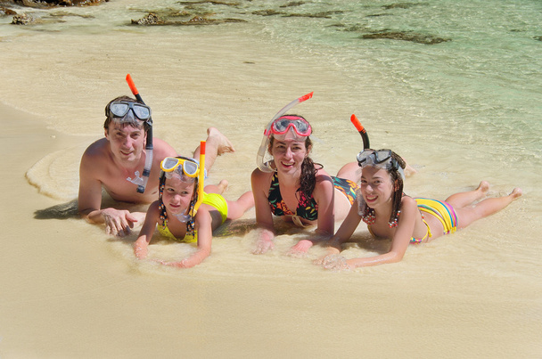 Happy family in snorkels on tropical beach - Photo, Image