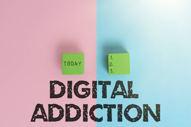 Handwriting text Digital Addiction. Internet Concept disorder that involves the obsessive use of mobile devices Two Objects Arranged Facing Inward Outward On a Separated Coloured Background - Фото, изображение