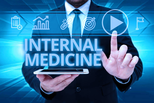 Handwriting text Internal Medicine. Business overview dedicated to the diagnosis and medical treatment of adults Man In Office Uniform Standing Pressing Virtual Button Holding Tablet. - Foto, immagini