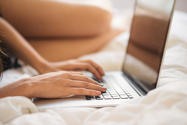 Typing on the laptop in bed - Zdjęcie, obraz