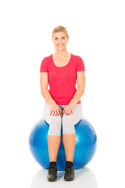 Fitness woman sitting on pilates ball - Photo, image