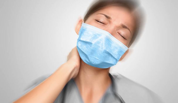 Doctor working at coronavirus emergency hospital wearing face mask tired feeling stress from work. Upset Asian woman healthcare worker - Foto, Bild