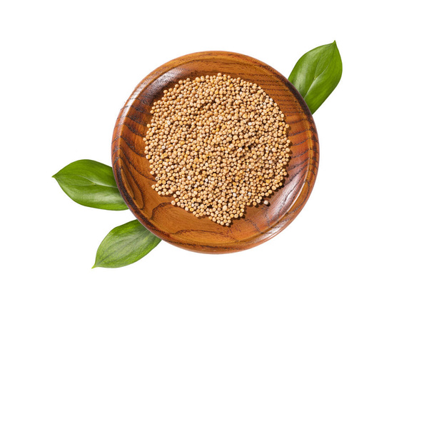 Organic white mustard seeds in the wooden bowl - Sinapis alba - Foto, afbeelding