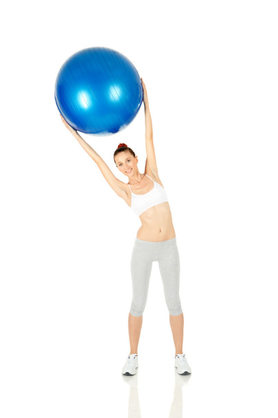 Fitness girl holding pilates ball - Фото, изображение