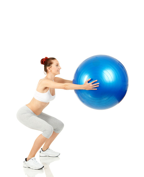 Fitness girl working with pilates ball - Photo, image
