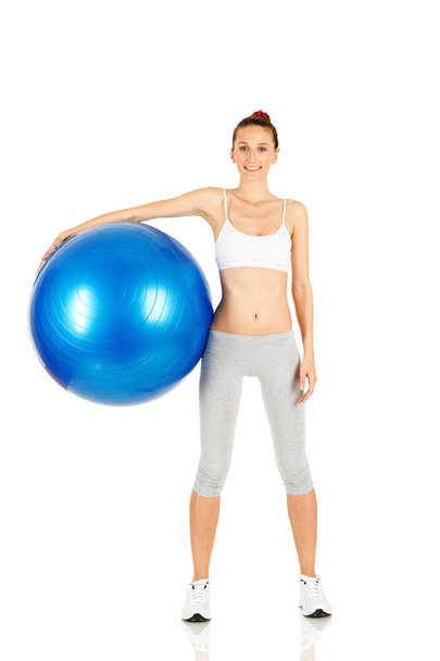 Fitness girl holding pilates ball - Foto, imagen