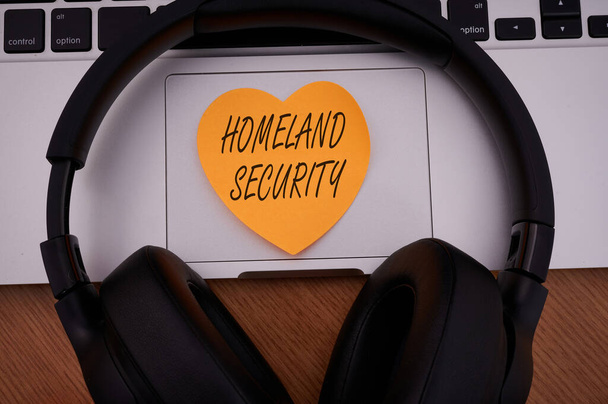 Hand writing sign Homeland Security. Concept meaning federal agency designed to protect the USA against threats Blank Notepad Laptop With Pen And Headphones Beside Cup Of Warm Coffee. - Foto, Imagem