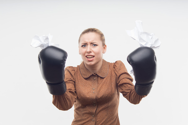 Business woman with boxing gloves and crumpled - Fotó, kép