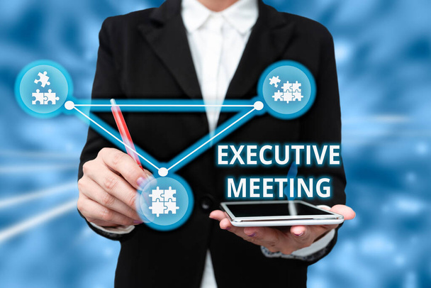 Text sign showing Executive Meeting. Business concept discuss a specific topic with boards and general members Lady In Uniform Holding Tablet In Hand Virtually Typing Futuristic Tech. - Photo, image
