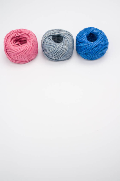 A closeup shot of soft colorful textile balls of wool on a white background with a copy space - Foto, imagen