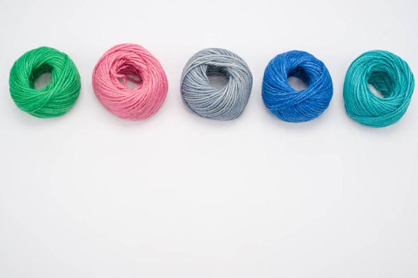 A closeup shot of soft colorful textile balls of wool on a white background with a copy space - Foto, Imagen