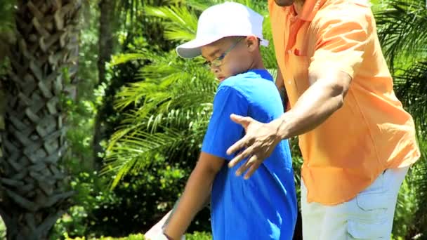 Father teaching son playing golf - Footage, Video